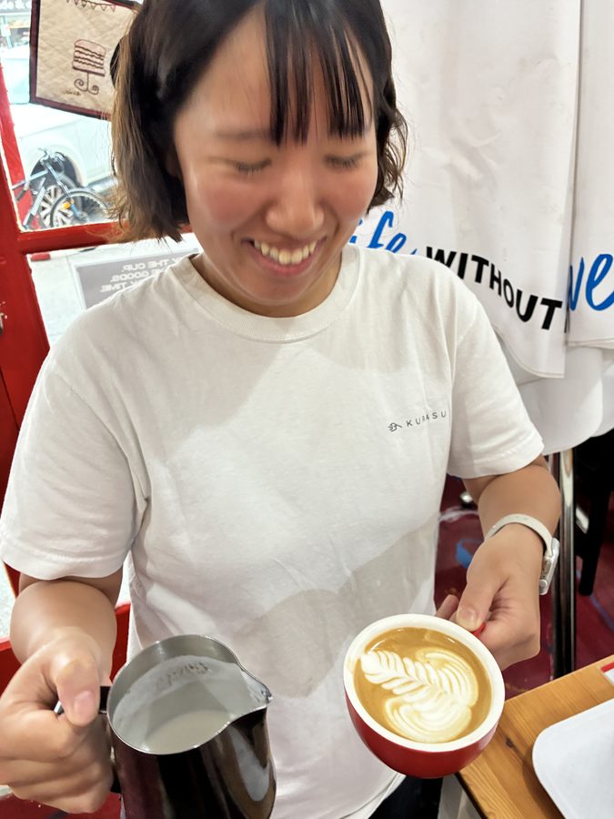 Student laughing with their finished coffee