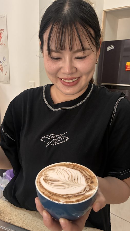 Student admiring their rosetta pour