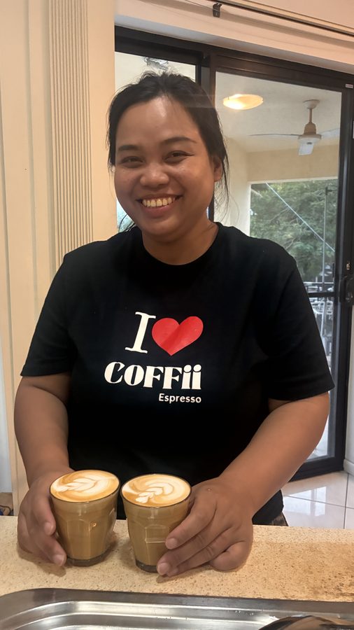 Student with two latte art coffees