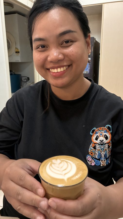 Student holding their first latte art
