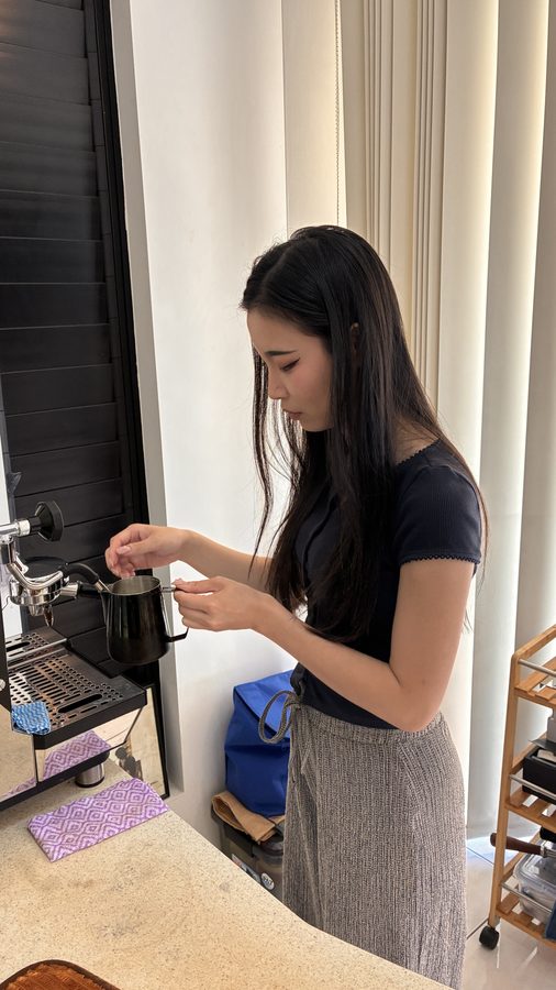 Student steaming milk on the espresso machine