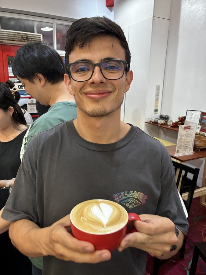 Student proudly showing their latte art