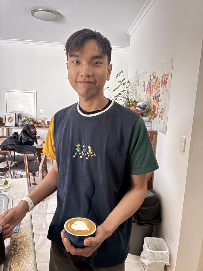 Student with heart latte art in red cup